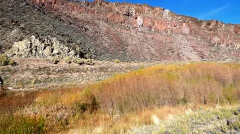 Metal Bridge Spanning Dramatic Red Rocks with Sagebrush Video stock 47474591