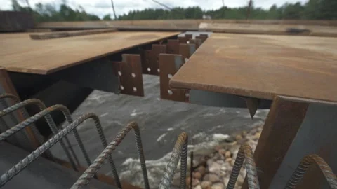 Metal bridge structure, fast flowing river, bank of stones Stock Footage 275335545