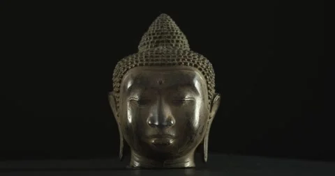 Metal Buddha's Head Rotating 360 Degrees Over Black Background Stock Footage 137453979