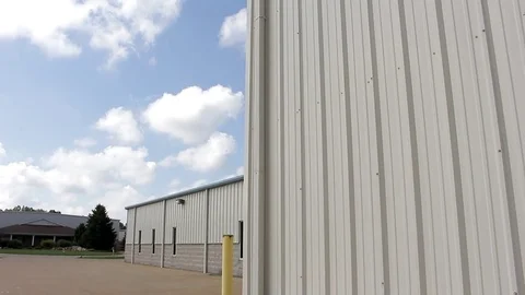Metal building side with blue sky Stock Footage 77631325