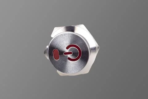 Metal button. background. it has a power symbol painted on it. close-up Stock Photos