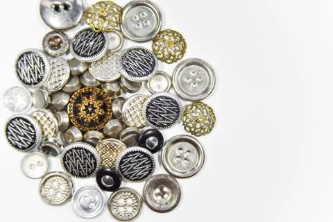 Metal buttons of different shape and size on the white background. Selective  Stock Photos