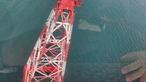 A metal cable car support standing in the sea. Video stock 317760281