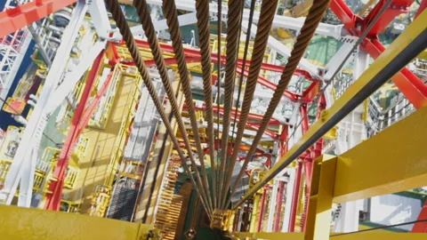 Metal cables go down. View down from Derrick. Offshore Drilling Platform. RIG Stock Footage 154329057