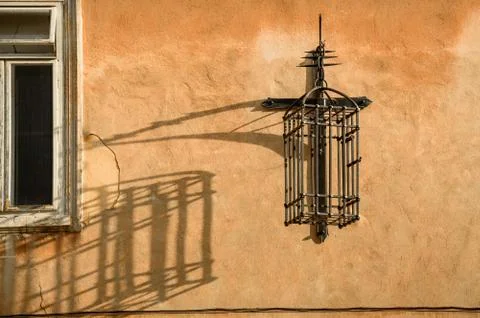 Metal cage suspended on the wall. Stock Photos