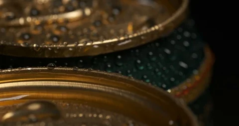 Metal cans stand on table, rotate slowly, fresh soft drink in package, close-up Stock Footage 119071802