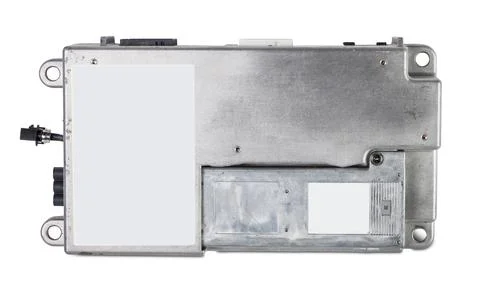 Metal car engine control unit with metal elements on a white isolated backgro Stock Photos