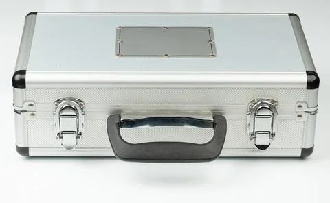 Metal case sits on a flat surface in a well-lit area Фото