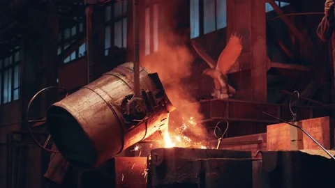 Metal cast process. Molten liquid iron pouring from ladle container into mold Stock Footage 159793151