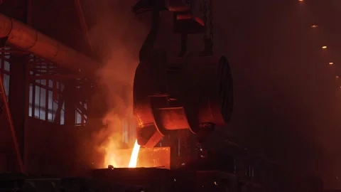 Metal cast process slow motion. Molten liquid iron pouring from ladle into mold Stock Footage 157239308