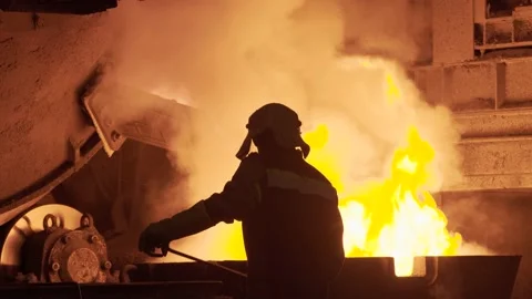 Metal casting at the factory, man works near furnace Stock Footage 203008564