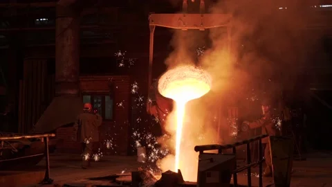 Metal casting process in foundry. Liquid molten metal pouring from ladle Video stock 154321744