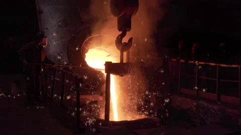 Metal casting process in foundry. Liquid molten metal pouring from blast furnace Stock Footage 154321966