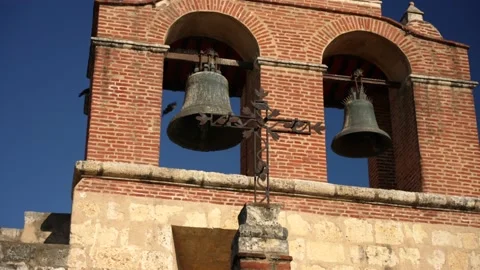 Metal Catholic Cross on the background of the tower with bells Stock Footage 169737576