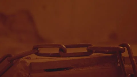 Metal chain and lock with a rusty link rocks. Flickering electric light in Stock Footage 238661645