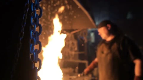 Metal chain on the background of a working blacksmith in blur Stock Footage 91413626