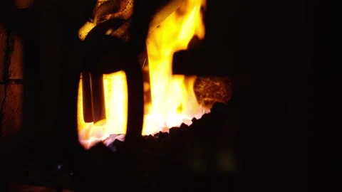 Metal chain links heating in a blacksmith forge with intense flames and blurred Stock Footage 328993587