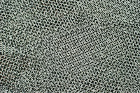 Metal chainmail ring pattern background close up Stock Photos