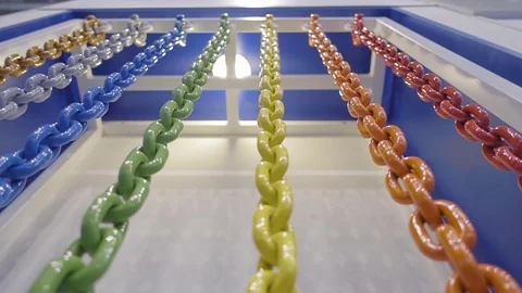 Metal chains of different colors hang together and shine in the light Stock Footage 71569591