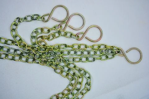 Metal chains, overflow chains and large hooks are arranged randomly. Stock Photos