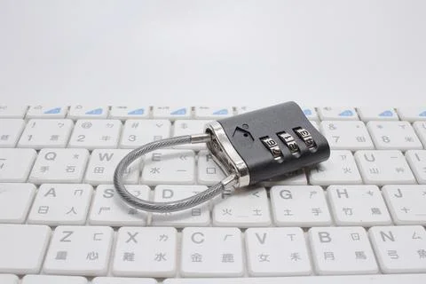 A Metal code padlock on laptop keyboard, space for text Stock Photos