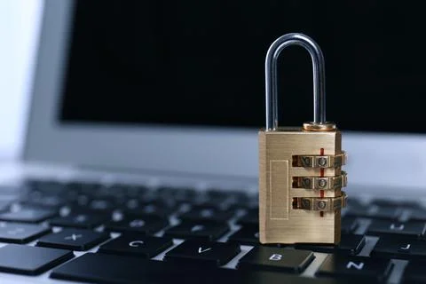 Metal code padlock on laptop keyboard, space for text. Cyber security concept Foto stock