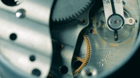 Metal cogs are moving inside of a clockwork mechanism Stock Footage 125547298
