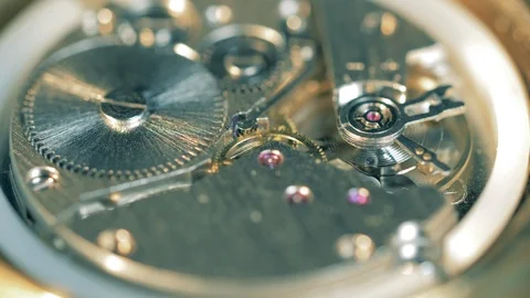 Metal cogwheels functioning in a clockwork mechanism Video stock 125495569