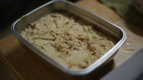 Metal container half filled with thick and rich hummus, filmed in slow Stock Footage 260794629