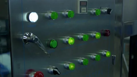 Metal control panel with green buttons on factory Stock Footage 144529446