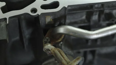 Metal coolant pipe attached with bracket to car engine block Stock Footage 340273755
