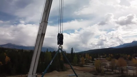 Metal crane pulley construction site circling drone aerial cloudy Stock Footage 333820162