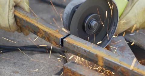 Metal cutter grinder tool being used to cut large piece of heavy steel Stock Footage 259081396