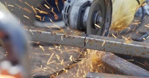 Metal cutter grinder tool being used to cut large piece of heavy steel Stock Footage 259083004