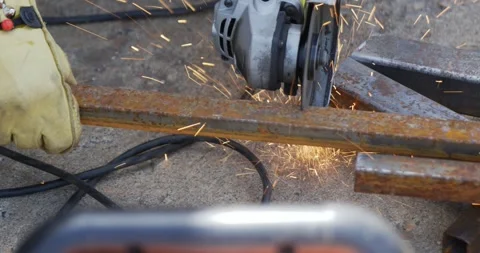 Metal cutter grinder tool being used to cut large piece of heavy steel Stock Footage 259083317