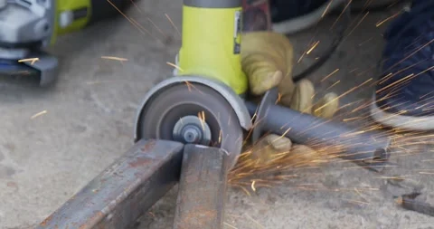 Metal cutter grinder tool being used to file sand down large pieces of heavy Stock Footage 259084537