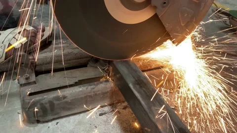 Metal cutting, Industrial Worker Using Angle Grinder and Cutting a Metal Tube Stock Footage 220184740