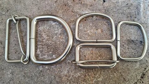 Metal D-rings and rectangular loops. Hardware fasteners for leather craft and Stock Photos