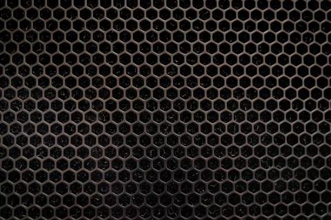 Metal dark gray surface hexagonal holes. background texture for desktop Stock Photos