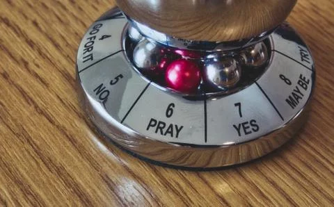 Metal decision maker with 'Pray' selected from the wheel of options Stock Photos