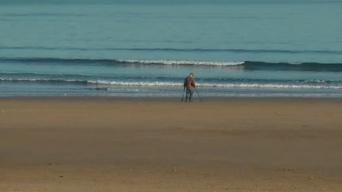 Metal detecting on beach Stock Footage 104312040
