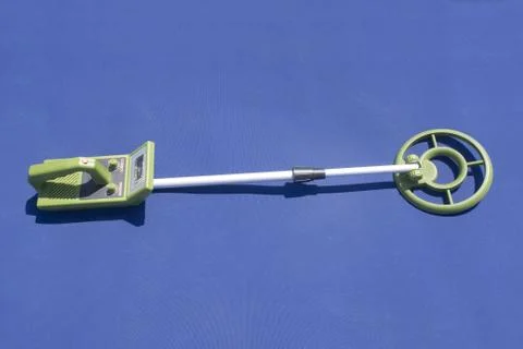 Metal detector on a blue surface Stock Photos