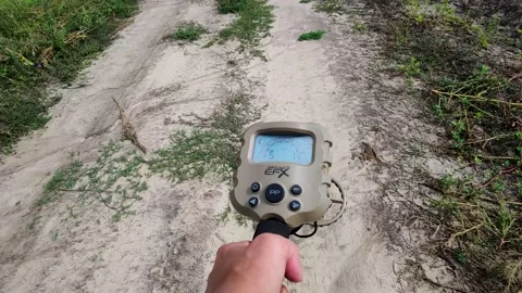 Metal Detector in Hand on the Background of the Road.  Stock Footage 204919538