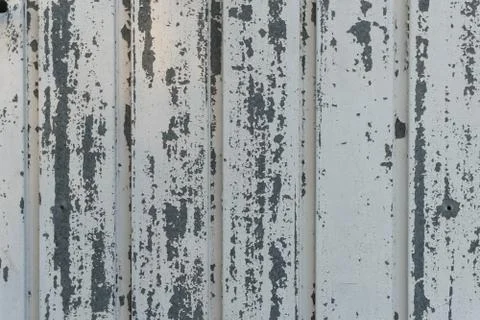 Metal door with uncorked white paint. Old door. Over the years.Texture. Stock Photos