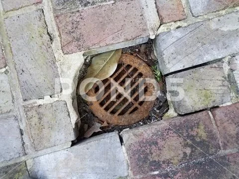 Metal drain and red and grey bricks or masonry Stock Photos