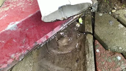 Metal drainpipe through which water flows and is blown by the wind. Video full Stock Footage 153349672