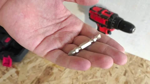 Metal drill bit for screwdriver, Power drill in hand close-up. Tool attachments. Stock Footage 322894278