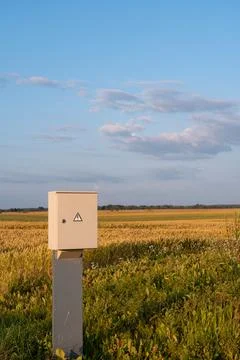 Metal electrical utility box featuring a high voltage warning symbol stands.. Stock Photos
