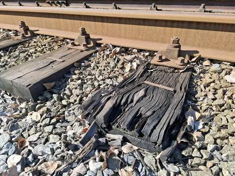 Metal elements of tram rail system, old rotten wooden sleepers Stock Photos
