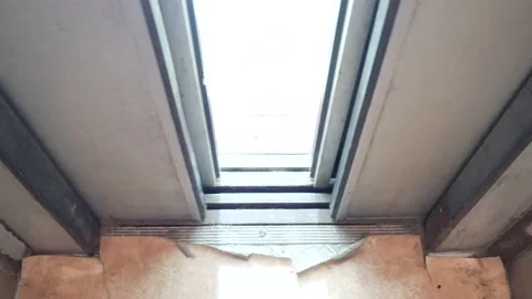 The metal elevator doors opened automatically. Vandalized interior of elevator Stock Footage 138598358